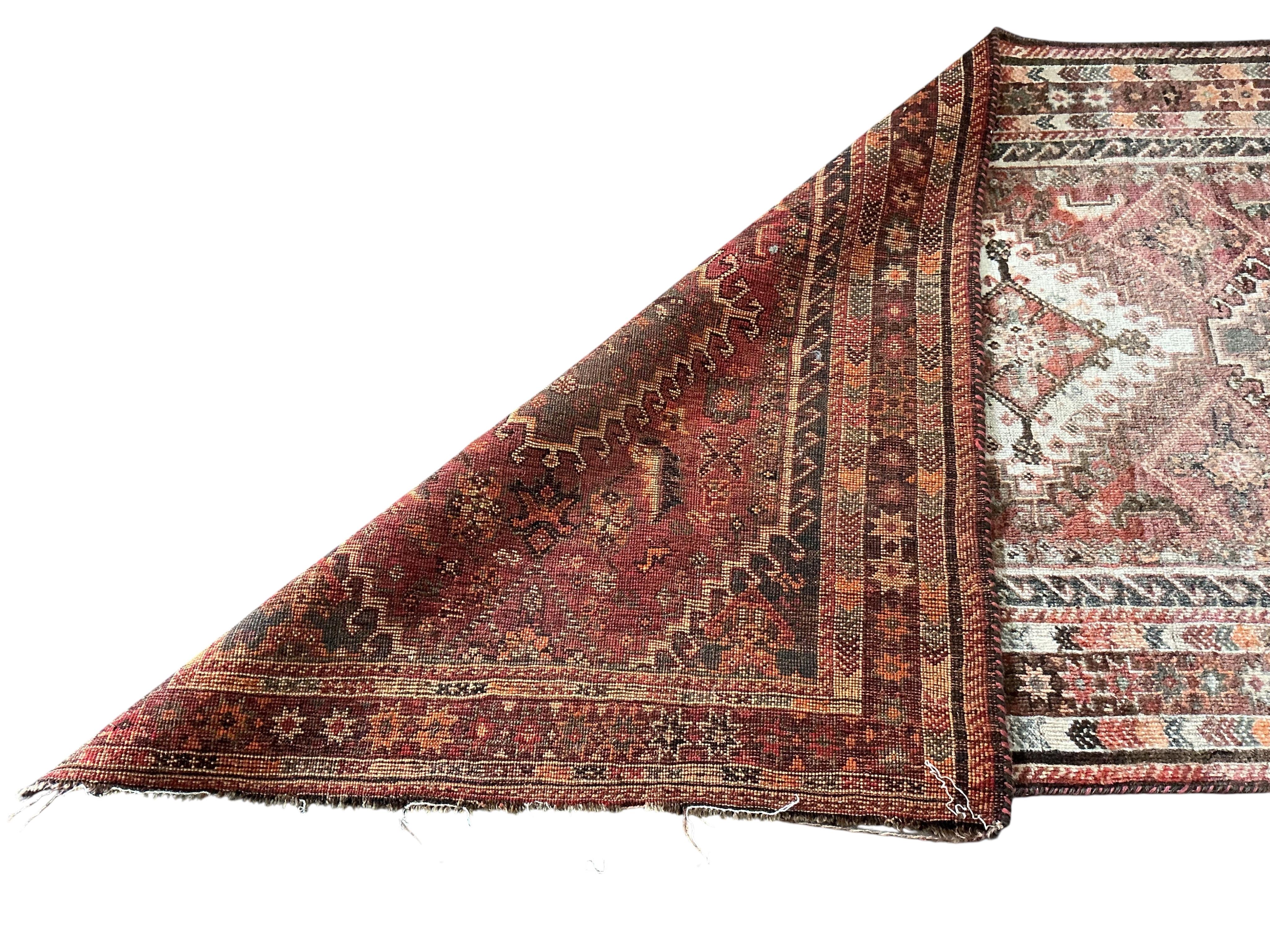A Hamadan red ground rug, some sun fading, 220 x 105cm